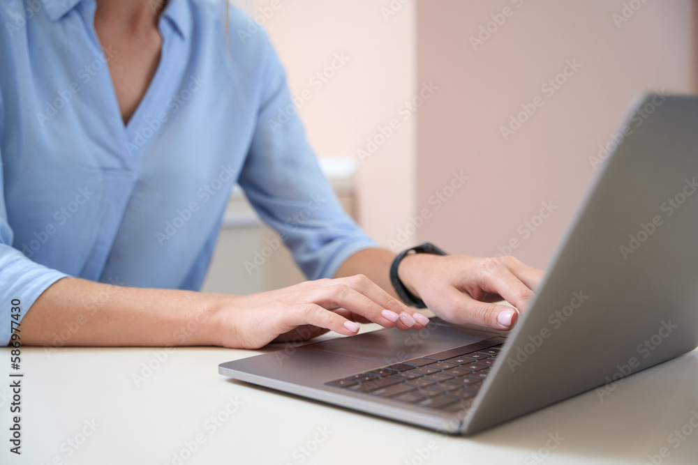 Elegant woman is working online and using laptop in her office Elegant woman is working online and using laptop in her office
