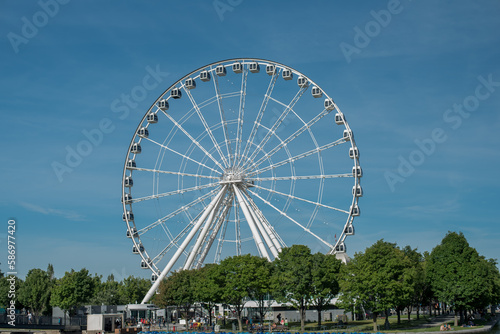 La grande Roue de Montreal, ferris wheel at Old Port Montreal, with blue sky. Montreal big wheel.