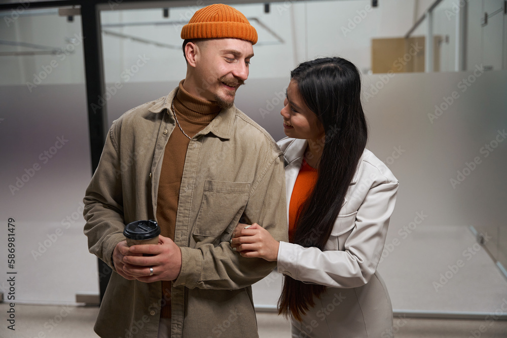 Two company employees flirting during coffee break Two company employees flirting during coffee break