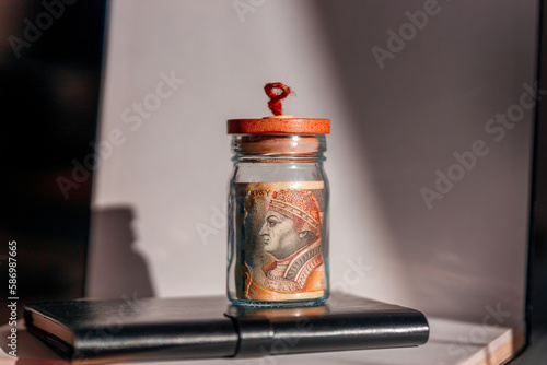 200 zlotys Polish money banknote in a jar. The concept of saving and spending in a time of rising inflation. The European financial crisis.