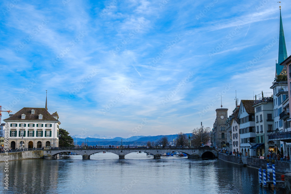 View on the Zurich lake shot from the limmat river. Blue Sky and a bridge can be seen in the picture.