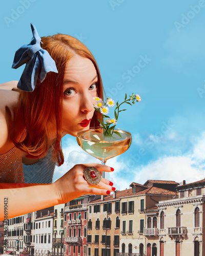 Pretty young redhead girl drinking cocktail over vintage buildings on daytime. Party time and travelling. Contemporary art collage. Concept of surrealism, travelling, imagination, fashion, beauty photo