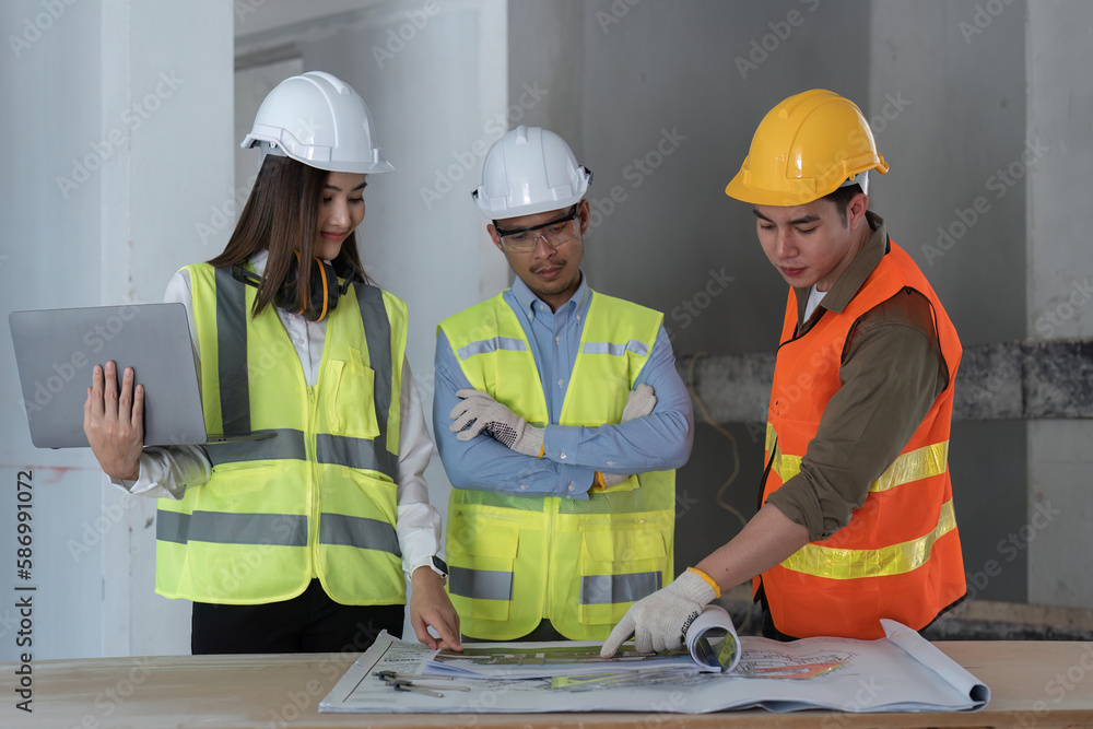 Team of engineer and architects working, meeting, discussing, designing, planning, measuring layout of building blueprints at construction site, Construction concept Team of engineer and architects working, meeting, discussing, designing, planning, measuring layout of building blueprints at construction site, Construction concept