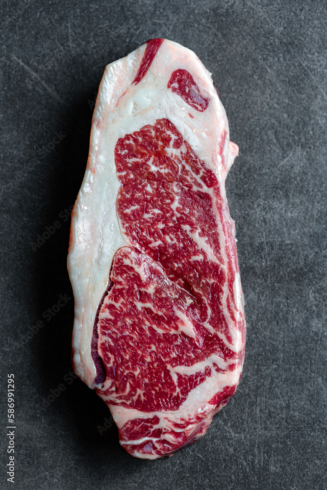 Raw Ribeye Steak on a Dark Background
