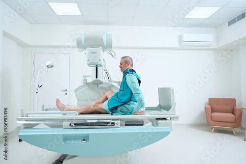 Smiling man making roentgenogram of his knee