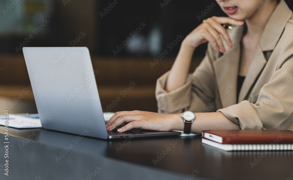 Young businesswoman working with laptop and documents on office desk. Young businesswoman working with laptop and documents on office desk.