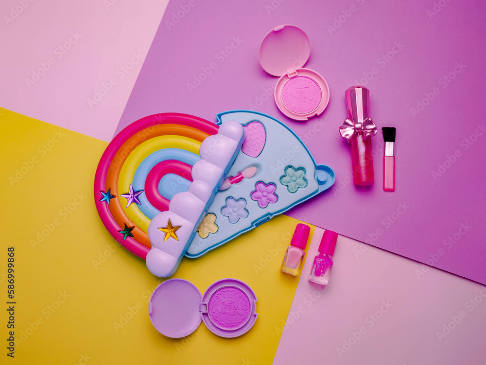 Children's set of decorative cosmetics for a little girl in the shape of a rainbow. Flat lay. Children's set of decorative cosmetics for a little girl in the shape of a rainbow. Flat lay.