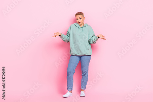 Full length photo of worried lady dressed stylish clothes showing gesture excuse me sorry no answer isolated on pink color background