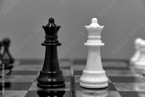 Two queens, two chess pieces opposite each other chessboard.