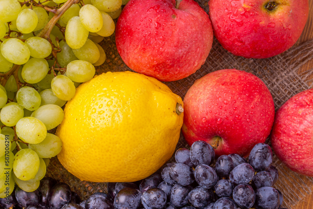 Different grapes and apples on a wooden background. Healthy food. Different grapes and apples on a wooden background. Healthy food.