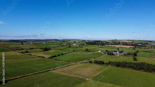 Clear sky over the green fields of southern Ireland. Picturesque summer landscape, sunny day. Green grass field under blue sky