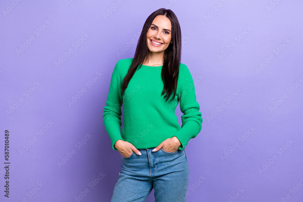 Photo of young successful entrepreneur model woman wear stylish outfit put hands pockets denim jeans smiling isolated on violet color background Photo of young successful entrepreneur model woman wear stylish outfit put hands pockets denim jeans smiling isolated on violet color background