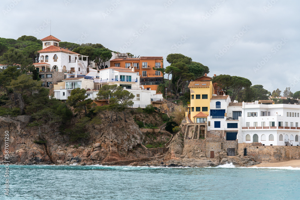 Old and modern residential buildings on the Costa Brava. Holiday homes on the rocky sea coast.