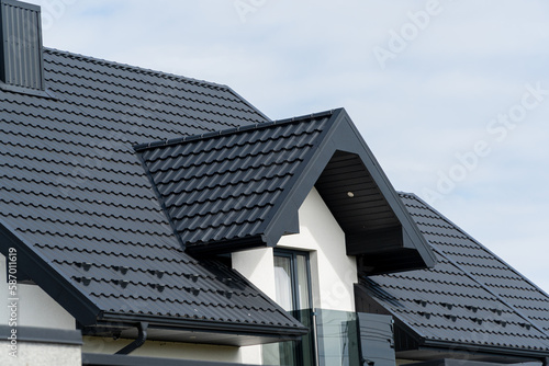 The roof of a modern new house. Tiled covering of building. Modern European house