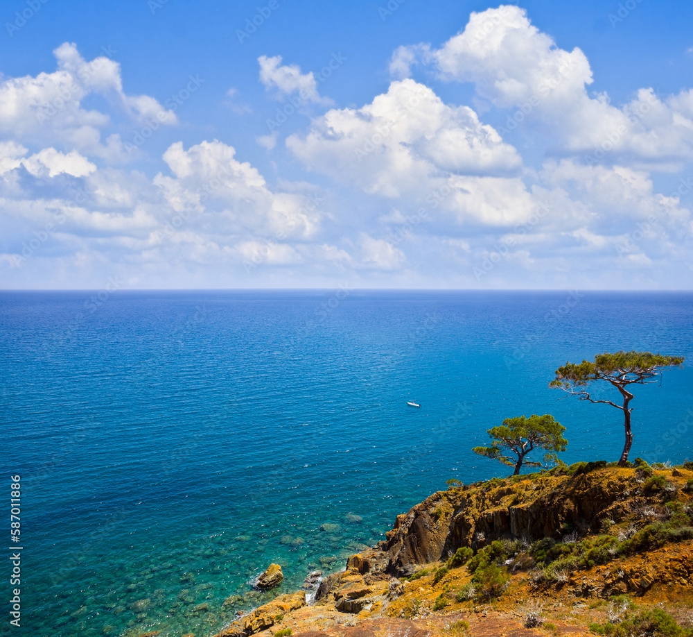 view from mountain hill to the emerald sea under a dense cloudy sky view from mountain hill to the emerald sea under a dense cloudy sky