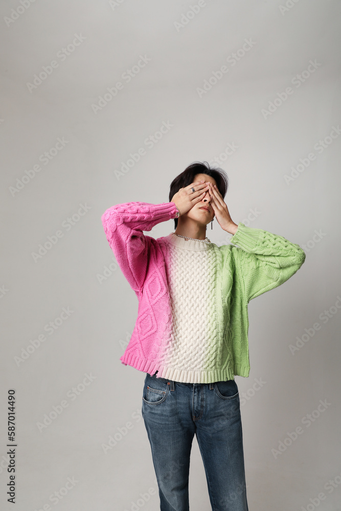 Confident young Asian man cover his face with hands. Vertical mock-up. Mind set. Confident young Asian man cover his face with hands. Vertical mock-up. Mind set.