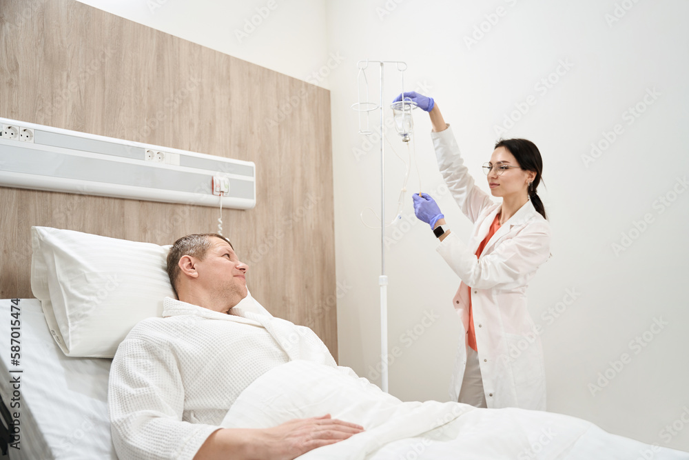 Caucasian male receiving professional treatment with medicine in hospital Caucasian male receiving professional treatment with medicine in hospital