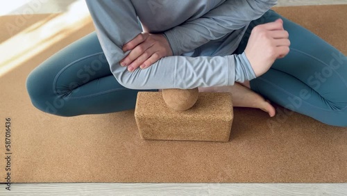 Forearm muscles myofascial release with large cork massage ball on cork yoga mat