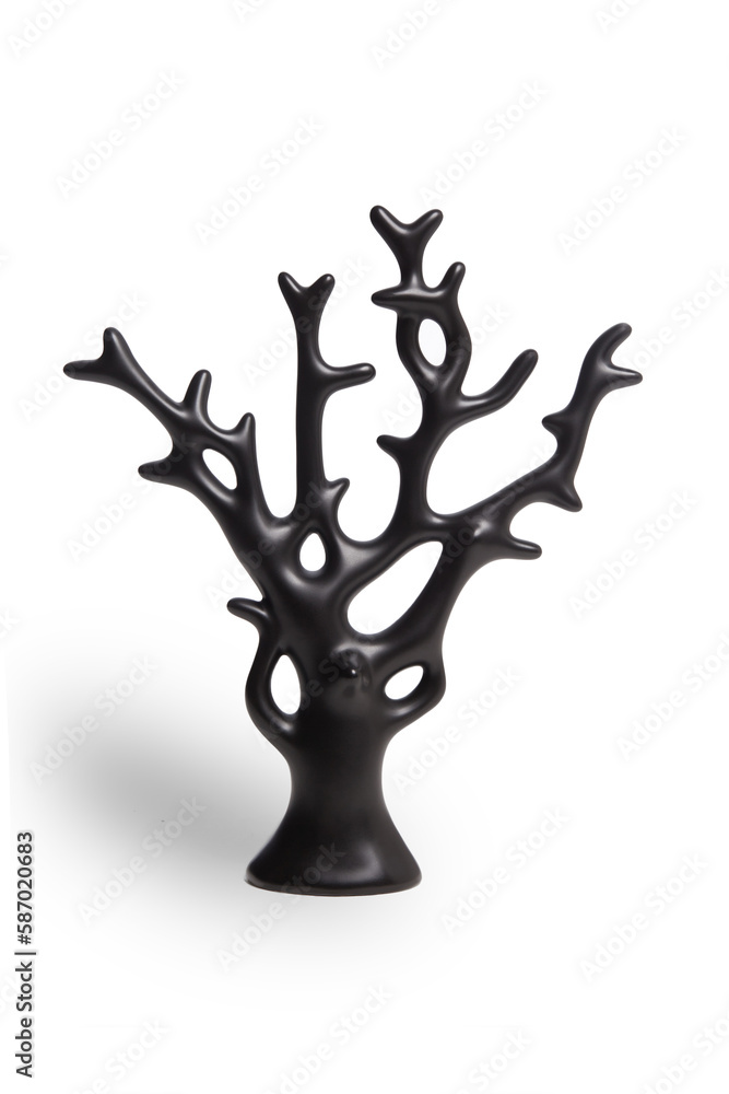 Close-up shot of a ceramic tree figurine covered with glossy glaze. Black ceramic statuette shaped as a tree is isolated on a white background. Front view.