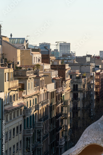 A view of the facades and roofs of a street in Barcelona. Typical Spanish residential buildings of the beginning of the 20th century.
