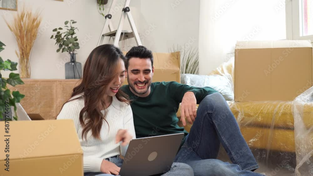 Happy couple using laptop on sofa Happy couple using laptop on sofa