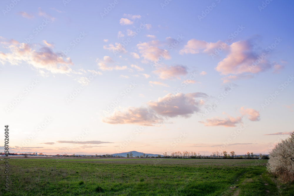 The sky with evening clouds over a field