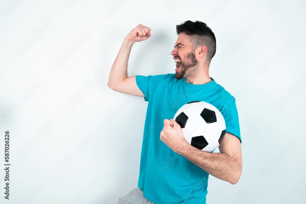 Profile photo of excited Young man holding a ball over white background good mood raise fists screaming rejoicing overjoyed basketball sports fan supporter Profile photo of excited Young man holding a ball over white background good mood raise fists screaming rejoicing overjoyed basketball sports fan supporter