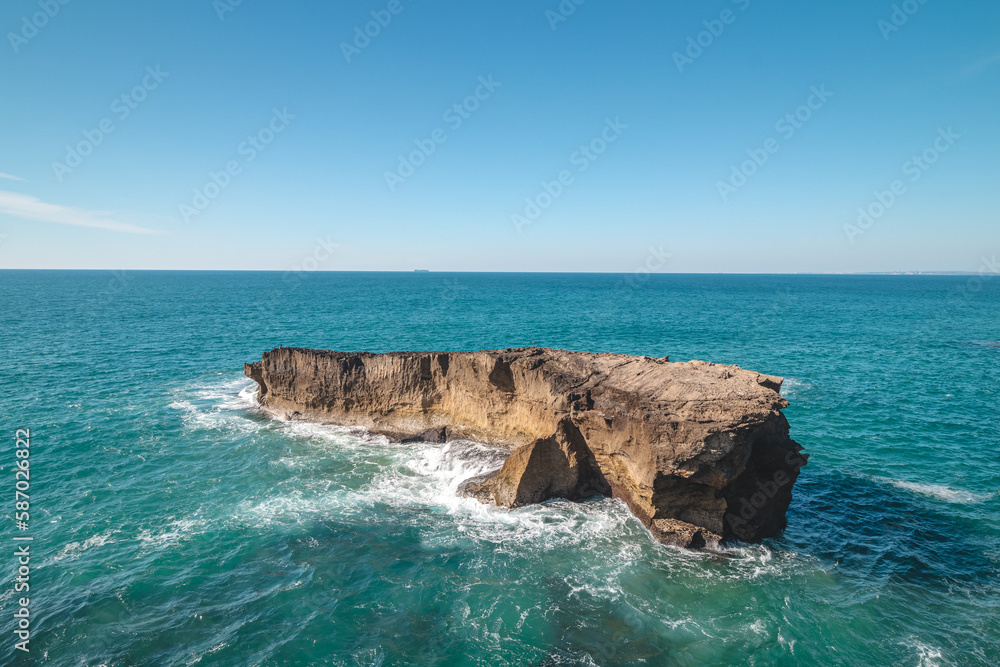Secluded rock reef with its own habitat in the Atlantic Ocean near Vila Nova de Milfontes, Odemira, Portugal. In the footsteps of Rota Vicentina. Fisherman trail