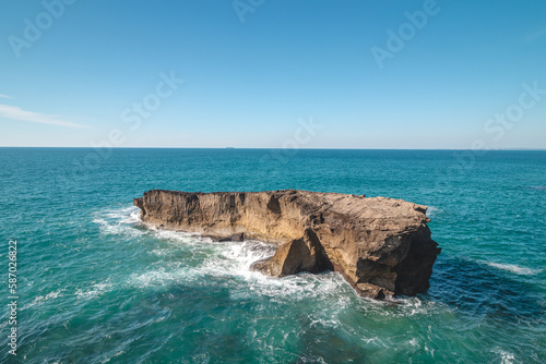 Secluded rock reef with its own habitat in the Atlantic Ocean near Vila Nova de Milfontes, Odemira, Portugal. In the footsteps of Rota Vicentina. Fisherman trail