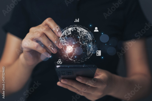 Businessman working on mobile phone with internet technology. The concept of targeting with a search system based on the world's population with AI.