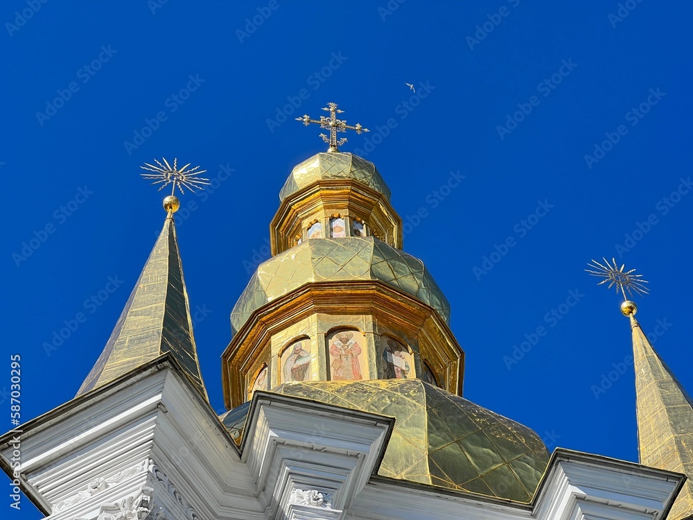 Golden domes bell tower against sky in orthodox monastery Lavra, Kyiv, Ukraine.