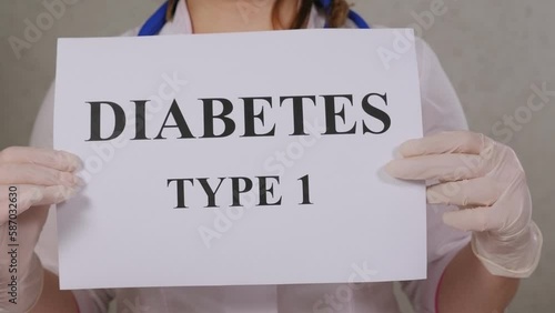 Close-up of a female doctor in a medical uniform holding a sign that says TYPE 1 DIABETES.  photo