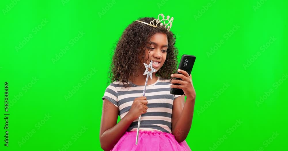 Princess, happy and child in a studio with green screen in celebration of good news on a phone. Happiness, technology and girl kid with a fairy cosplay outfit and cellphone by chroma key background. Princess, happy and child in a studio with green screen in celebration of good news on a phone. Happiness, technology and girl kid with a fairy cosplay outfit and cellphone by chroma key background.