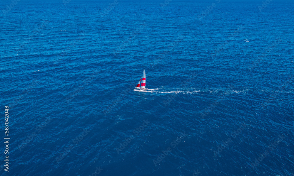 Aerial view beautiful white yacht wirh sail on clear blue sea in Turkey. Concept sport travel by drone