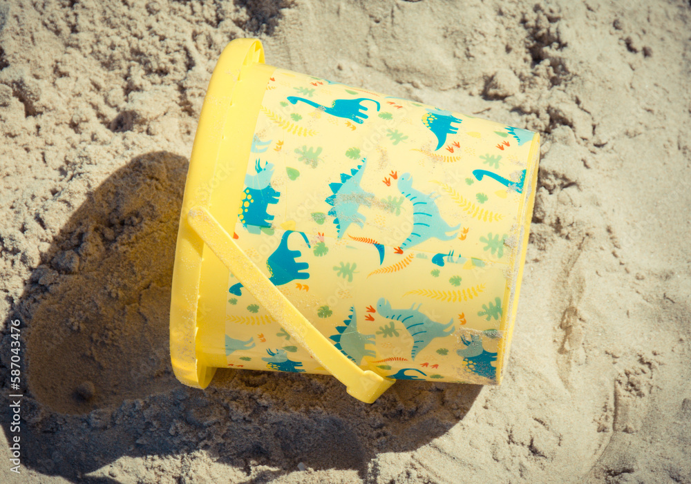 Plastic bucket using for relax and playing at beach. Summer, vacation time and child development Plastic bucket using for relax and playing at beach. Summer, vacation time and child development