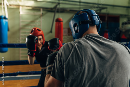 Two people practice boxing with protection