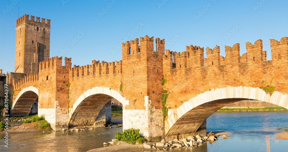 Verona, Italy. Castelvecchio bridge on Adige river. Old castle sightseeing at sunrise.