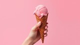 Hand holding strawberry ice cream cone on pink background. Generative AI.