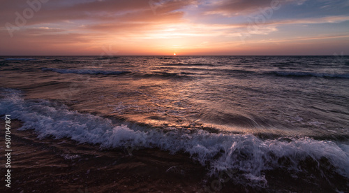 Sunset over the sea shore  waves