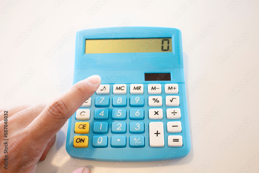 Calculator and hand on white background, business and finance concept Calculator and hand on white background, business and finance concept