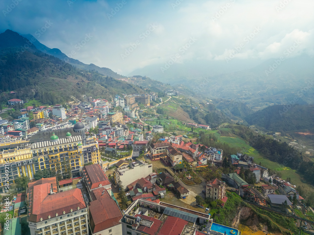 Aerial view of landscape at the hill town in Sapa city, Lao Cai Province, Vietnam in Asia with the sunny light and sunset, mountain view in the clouds