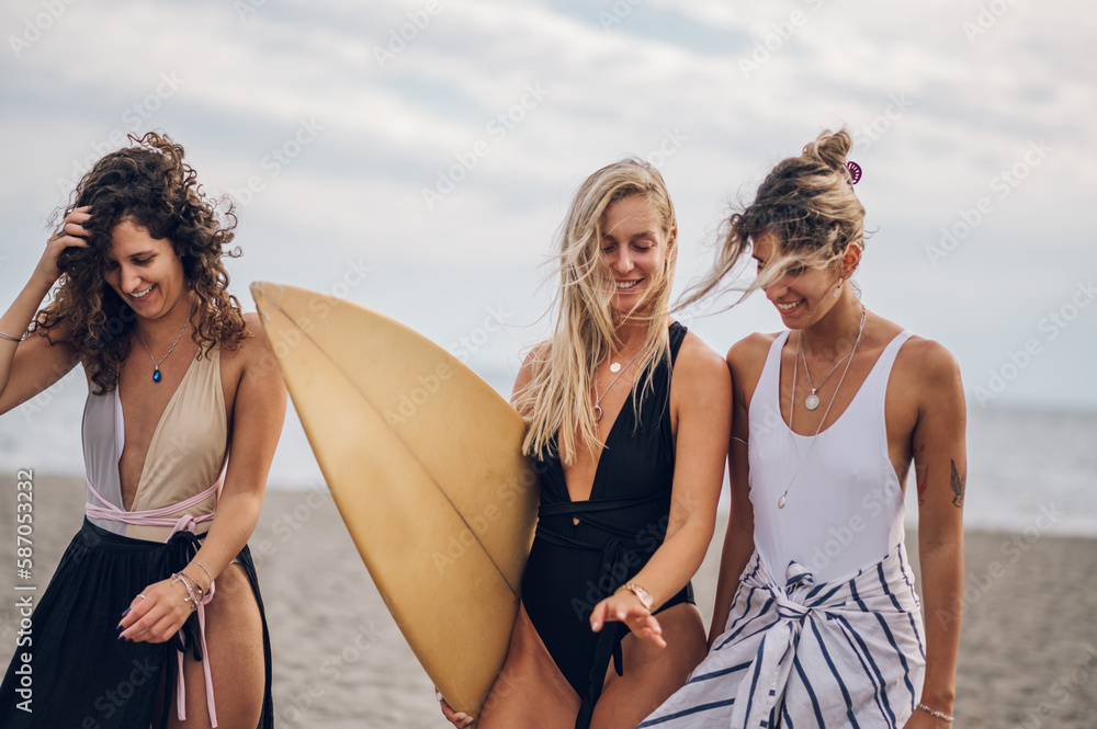 Three beautiful woman friends having fun on a beach Three beautiful woman friends having fun on a beach
