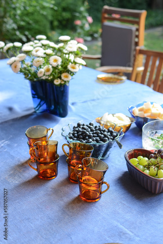 outdoor tea. cups for tea and fruits on a table in the garden