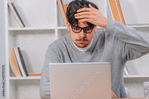 surprised student looking at computer or laptop photo