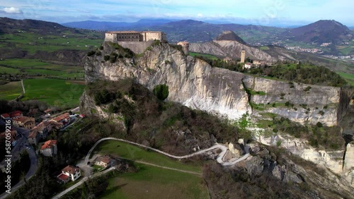 Unique beautiful places of Italy. Emilia Romagna region. Aerial drone view of impressive San Leo medieval castle located in the top of sandstone rock and village photo