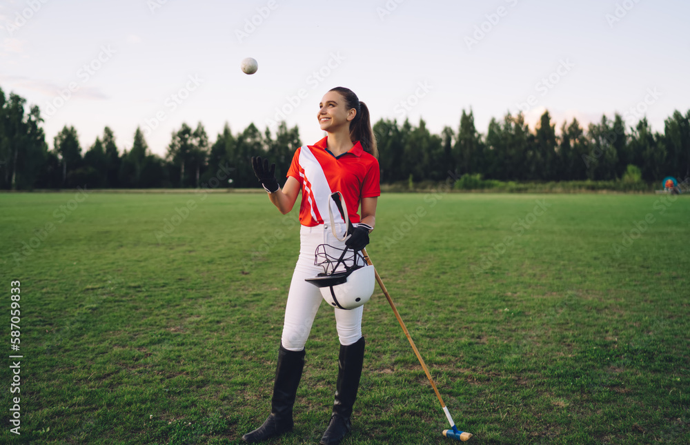 Smiling woman in uniform with polo ball