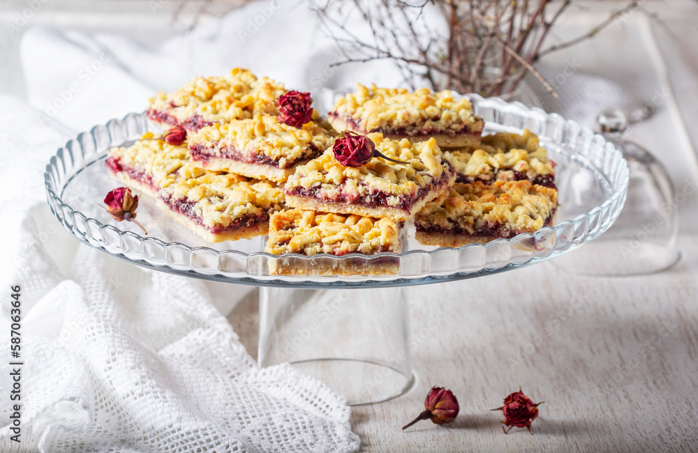 Streusel pie with currant and rose petal filling on a light background.
