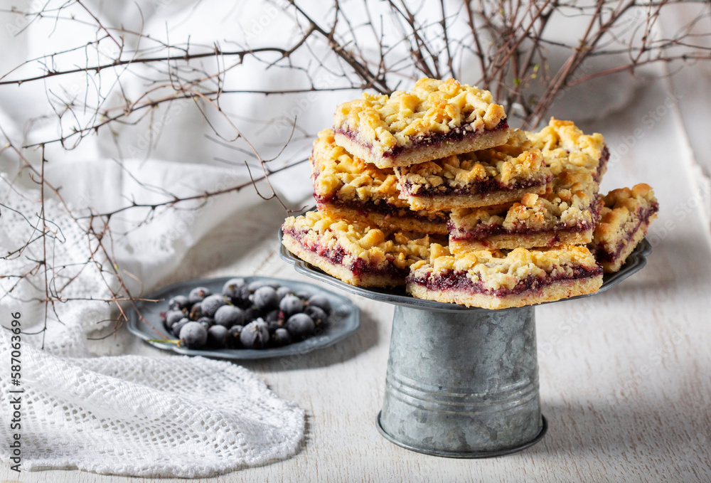 Streusel pie with currant and rose petal filling on a light background.