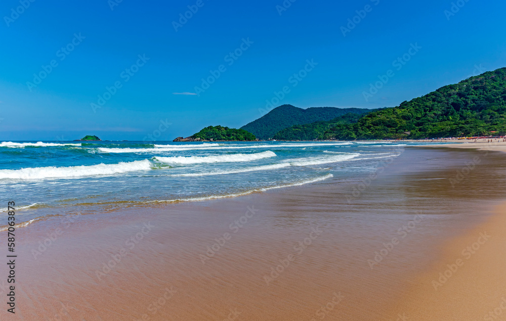 Paradise tropical beach surrounded by preserved rainforest and mountains in Bertioga on the coast of the state of Sao Paulo Paradise tropical beach surrounded by preserved rainforest and mountains in Bertioga on the coast of the state of Sao Paulo
