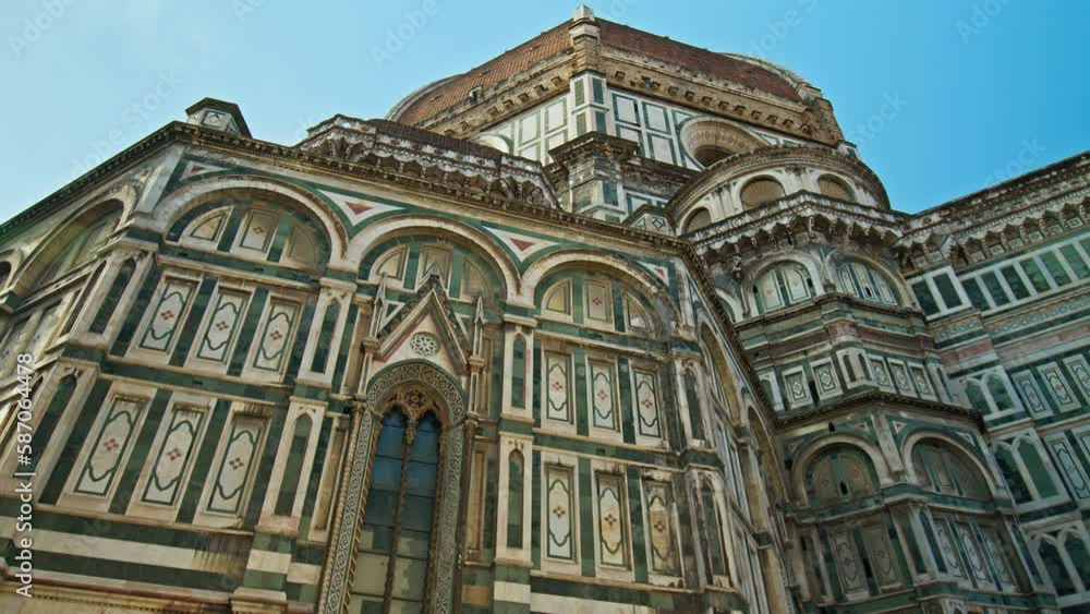 Close-up of the stunning Cathedral of Santa Maria del Fiore. Amazing Landmark cathedral with red-tiled dome, colored marble facade and elegant Giotto tower in Florence, Italy. Close-up of the stunning Cathedral of Santa Maria del Fiore. Amazing Landmark cathedral with red-tiled dome, colored marble facade and elegant Giotto tower in Florence, Italy.